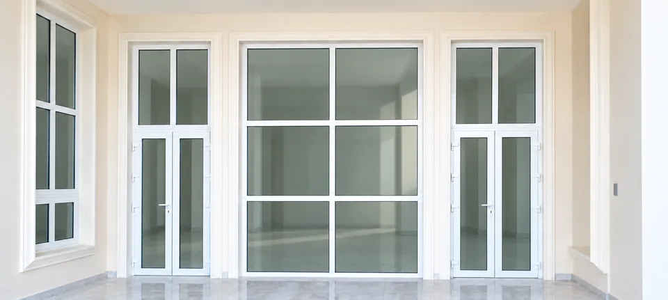 Installed doors and forced-entry-resistant glass panels with white frames; retouched photo.