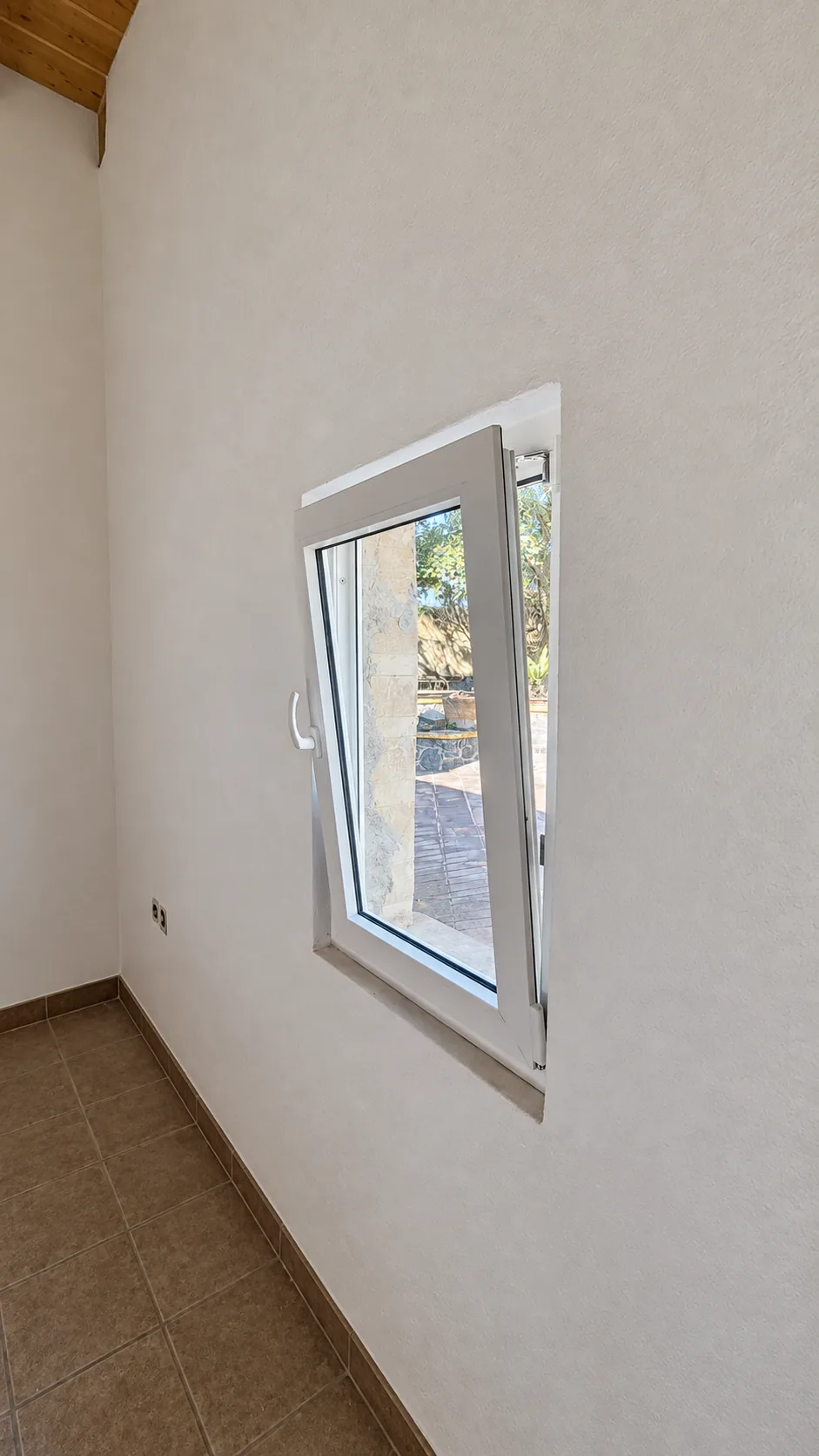 PVC tilt-and-turn window with forced-entry-resistant glass, open inward.