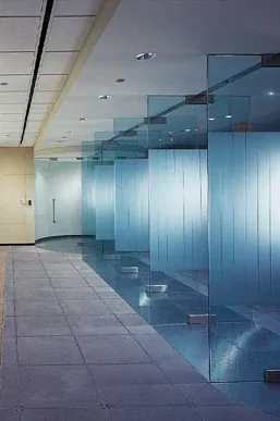 Laminated glass partitions along a corridor.